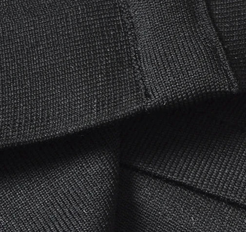 Close-up of black fabric texture with a focus on stitching details.