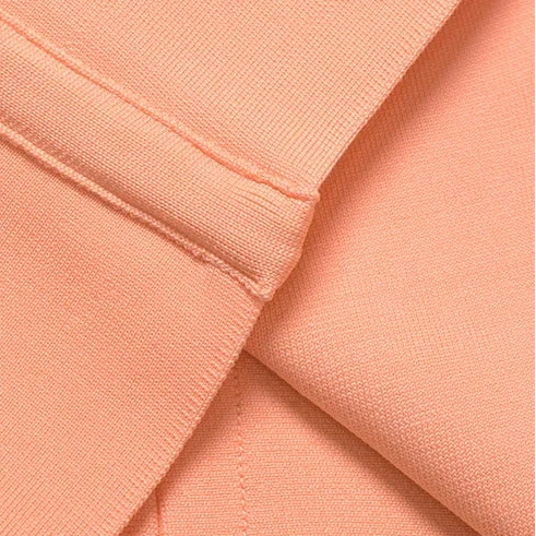 Collage of peach-colored fabric with different textures and folds.