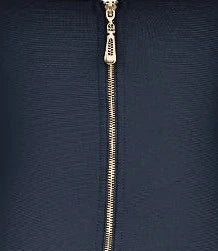 Black dress with a gold zipper on a white mannequin against a white background