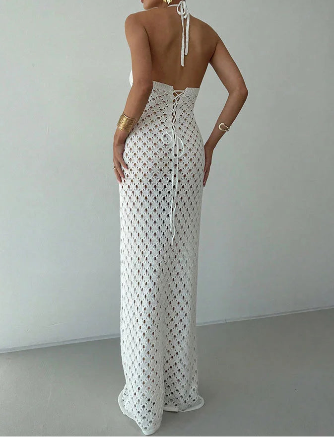 Woman wearing a white lace dress with a plain background