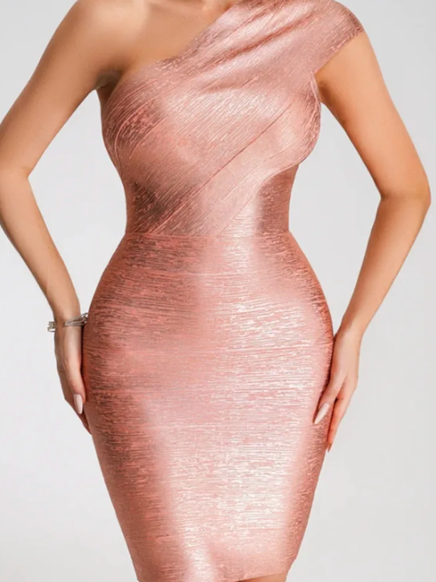 Rose gold one-shoulder dress on a plain background
