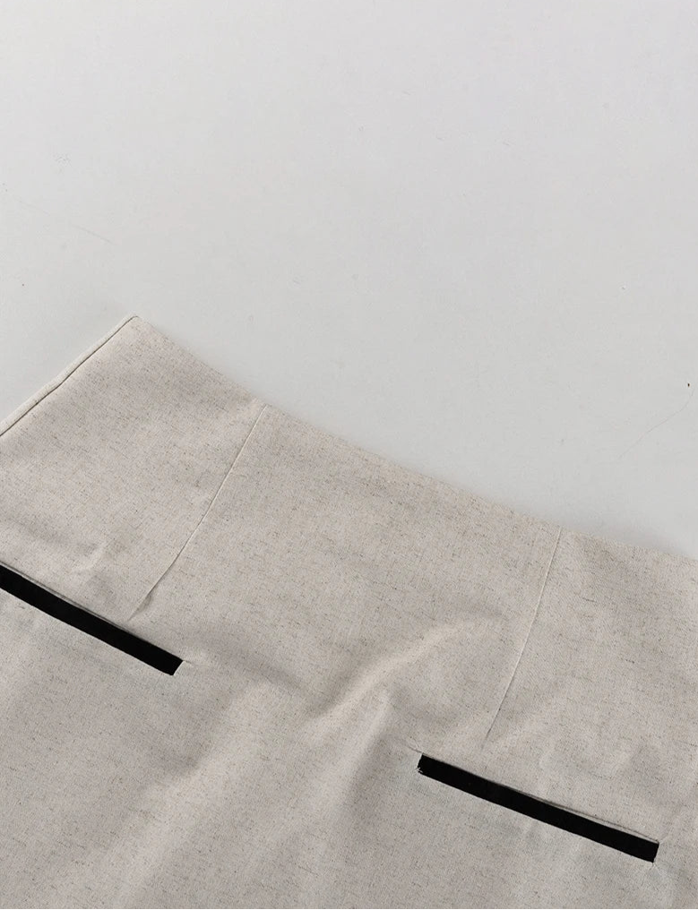 Light gray apron with black straps on a white background