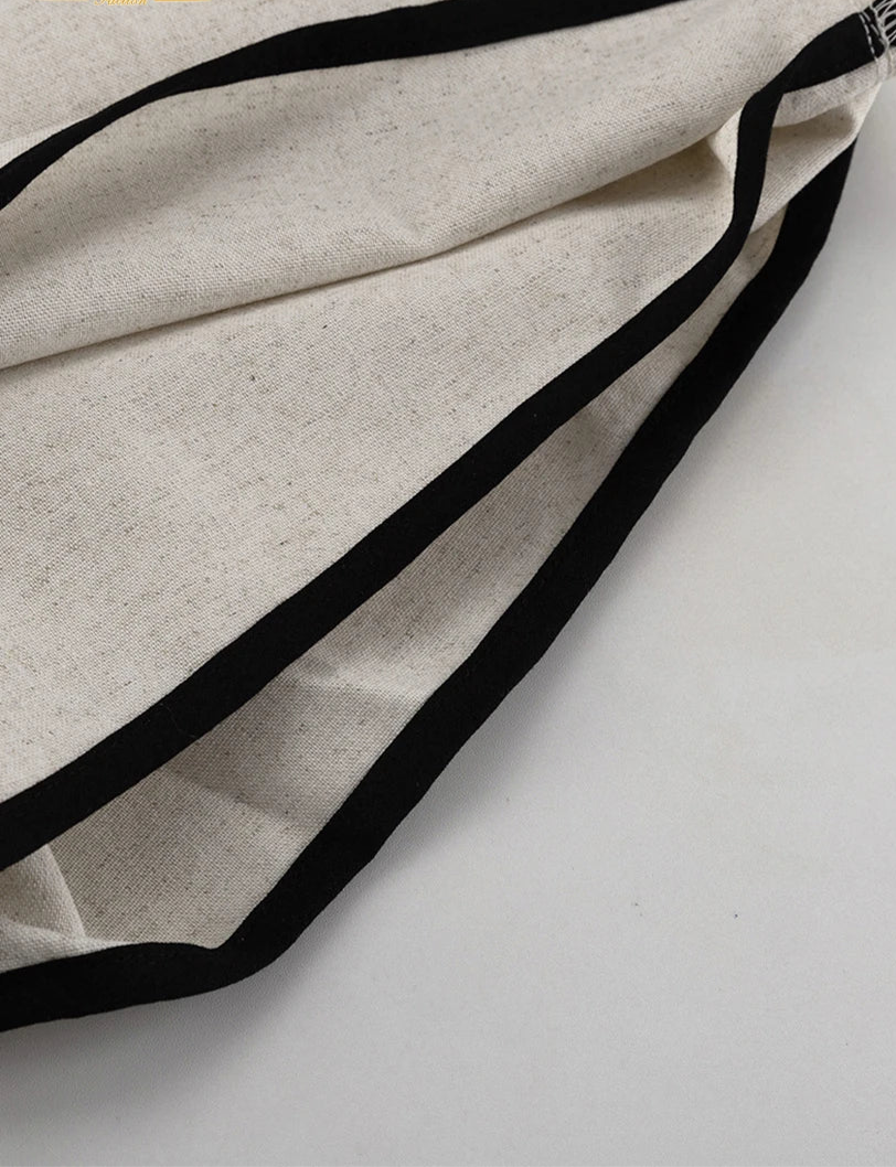 Close-up of beige fabric with black elastic band on a white background